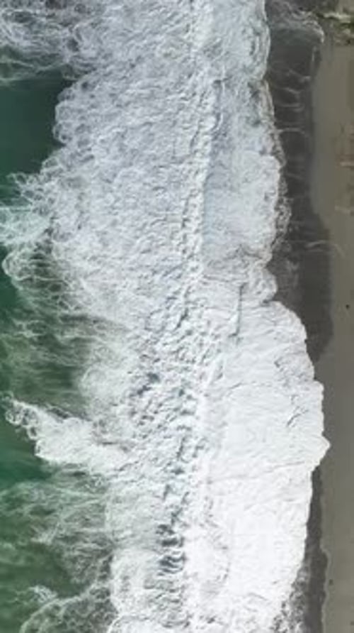 Ocean Waves Crashing on Sandy Beach Shoreline