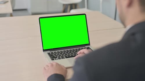 Businessman Using Laptop with Green Screen