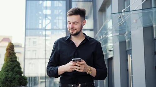Young Man Using Smartphone in Urban Setting