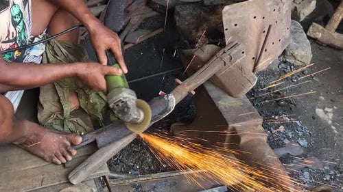 Labourer Using Angle Grinder On Blade At Workshop In Dhaka, Bangladesh