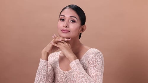 Woman with Hands at Chin Smiling