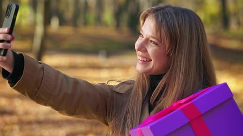 Stylish Fashionable Woman Walking in Park in Autumn