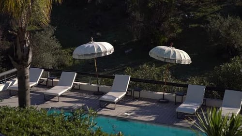 Umbrellas and Sunbeds By the Pool