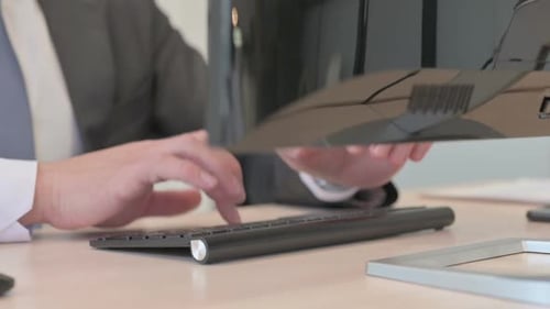Close Up of Young Businessman Working on Computer, Typing