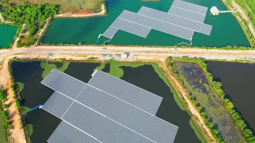 4K : Aerial view of a large floating solar panel during sunrise