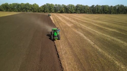 Tractors plowing the field in Ukraine