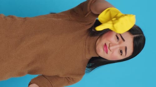 Woman Puts on Rubber Glove, Wipes Above