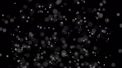 Smooth falling particles from top to bottom. Seamless animation of particle movement with blur and b