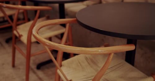 Minimalist Wood Chairs at Empty Restaurant Table