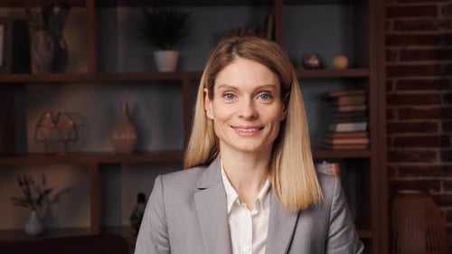 Smiling Woman in Blazer Poses Indoors
