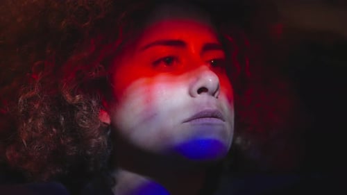 Woman's Face in Dramatic Red and Blue Lighting