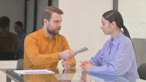 Young Man giving Money to Woman and Shaking Hand