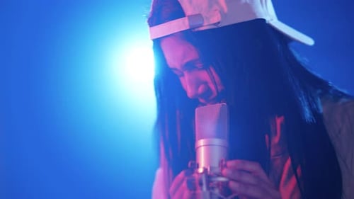 Young Female Reggaeton Singer Performing in a Music Studio