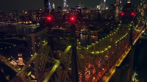 Rising above Ed Koch Queensboro Bridge with blinking red lights on tops. Incredible city panorama