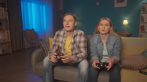 Couple playing video games in living room