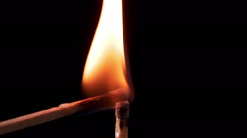 Igniting Match Lights With Bright Flame On Black