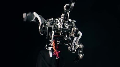 Modern Robotic Arm Holding and Moving Man Working with Mechanical Components Engineers Using Tablet