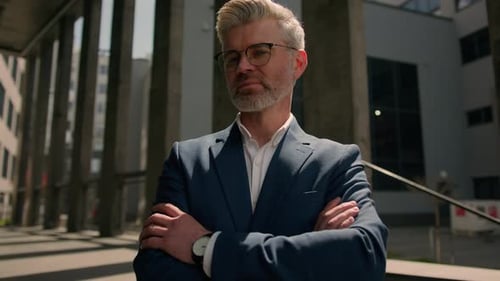 Confident Businessman Smiling Outside Corporate Office Building