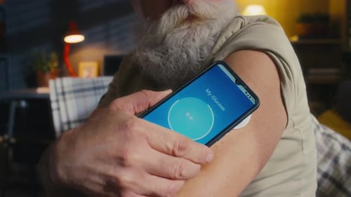 Man Scans Glucose Monitor With Smartphone