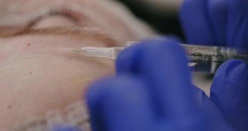Crop Cosmetician Making Collagen Injection