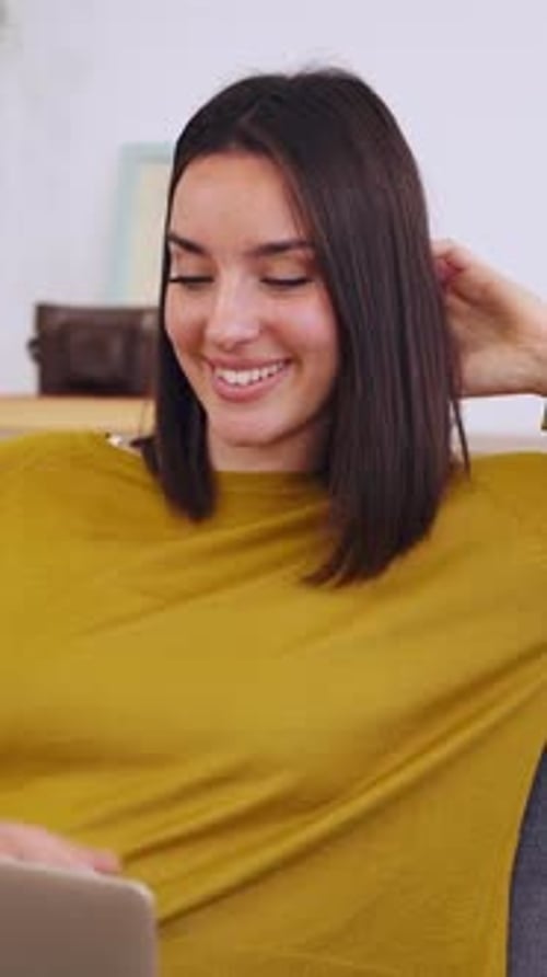 Smiling Woman Using Laptop at Home Indoors