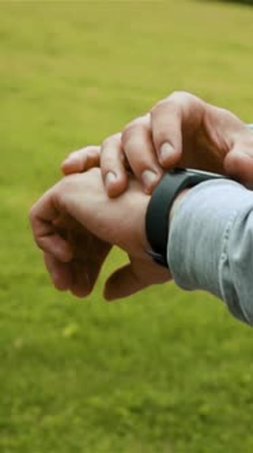 Adult using Smartwatch in Nature Setting