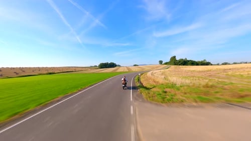 Motorcycle Riding a Road in Summer