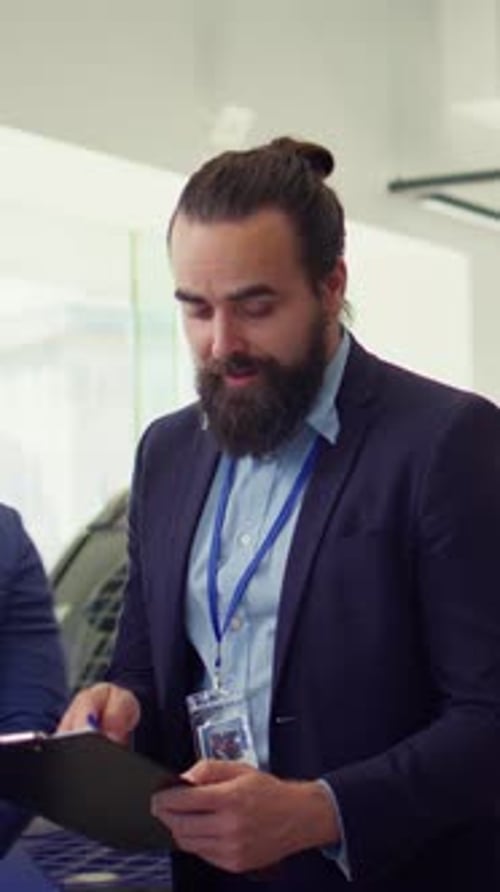 Vertical Video Friendly Car Salesman Showcasing Dealership Vehicles to Clients