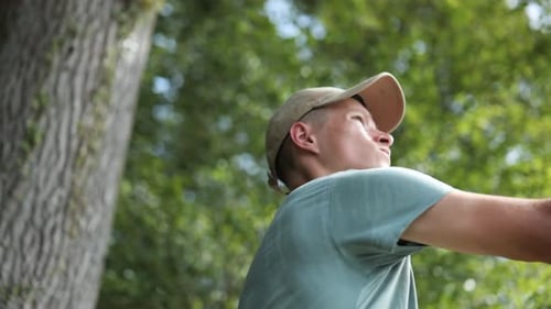 Young Man Fishing with a Pole in Nature