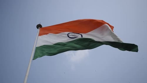 Indian Flag Waving Against a Blue Sky