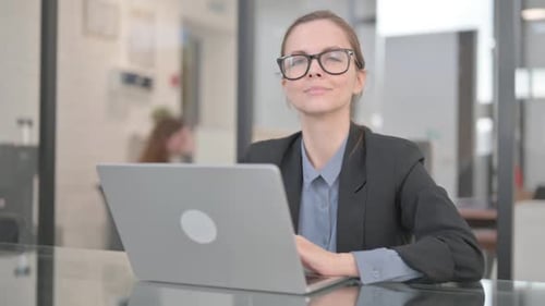 Businesswoman Smiling at Camera while in Office