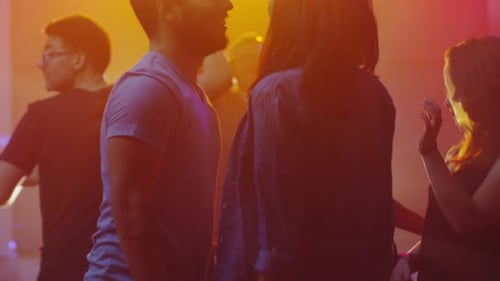 Young Adults Dancing at Nightclub with Confetti