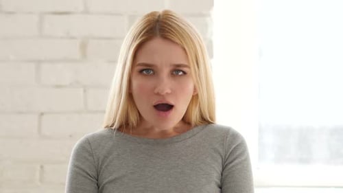 Surprised Woman Looking at the Camera Indoors