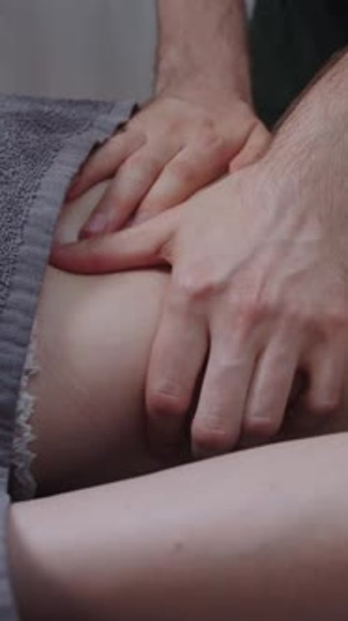 Massage in Clinic a Man Therapist Massaging Bare Back of