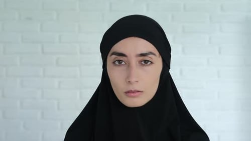 Woman in Head Covering with Serious Expression