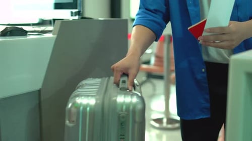 Close up hands of passenger bring luggage to counter and staff or cabin crew serve