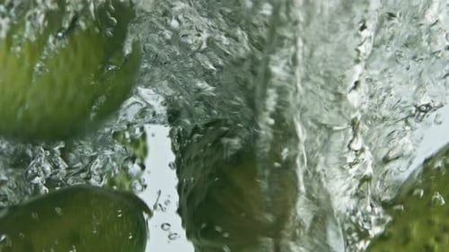 Cucumbers Falling into Water Creating Bubbles