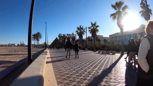 Time Lapse of people walking on the Malvarrosa Beach promenade in Valencia, Spain