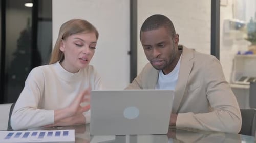 Professionals Collaborating During Online Meeting in Office