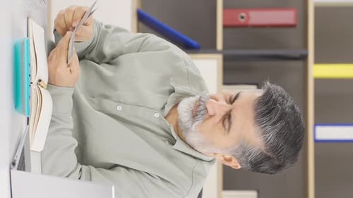 Vertical video of Businessman doing company accounting.