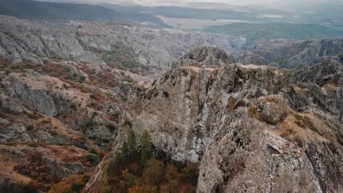 Drone Footage of Mountains and Rock Formations Covered By Plants Filmed in Georgia