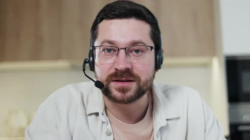 Male Wearing Wireless Headset Having Online Video Call Through Modern Gadget