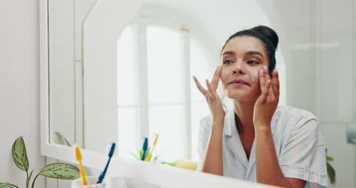 Happy woman, face and lotion with mirror for skincare, morning routine or hygiene at home spa