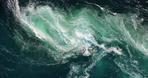 Blue waves of water of the river and the sea meet each other during high tide and low tide.