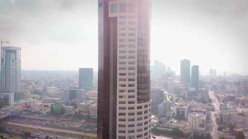 Aerial footage of Skycraper and polluted city