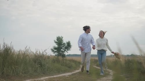 Loving Couple Runs Together on Rural Path