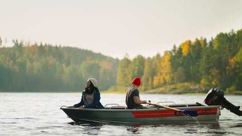 Active Young People Boating In River In Weekend Trip Man And Woman Travelers Admiring Landscape