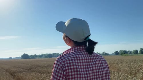 Young Woman Farmer Enjoying Sunrise Standing at Agricultural Field