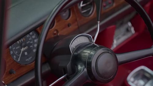 close up of vintage car steering wheel and dashboard interior