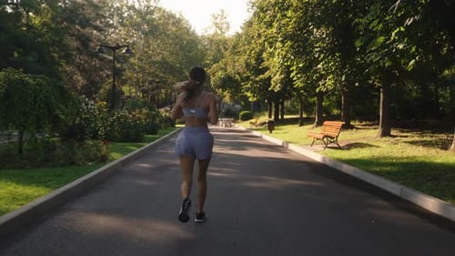 Young Woman Jogging In The Park